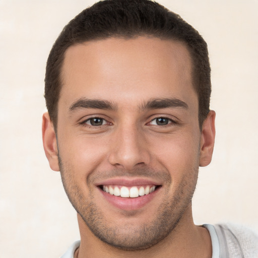 Joyful white young-adult male with short  brown hair and brown eyes