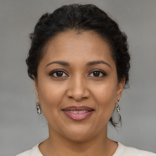 Joyful latino young-adult female with short  brown hair and brown eyes