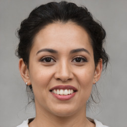 Joyful white young-adult female with medium  brown hair and brown eyes