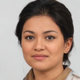 Joyful latino young-adult female with medium  brown hair and brown eyes