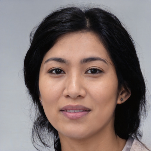 Joyful asian young-adult female with medium  black hair and brown eyes
