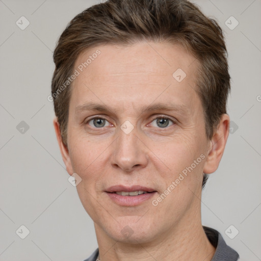 Joyful white adult male with short  brown hair and grey eyes