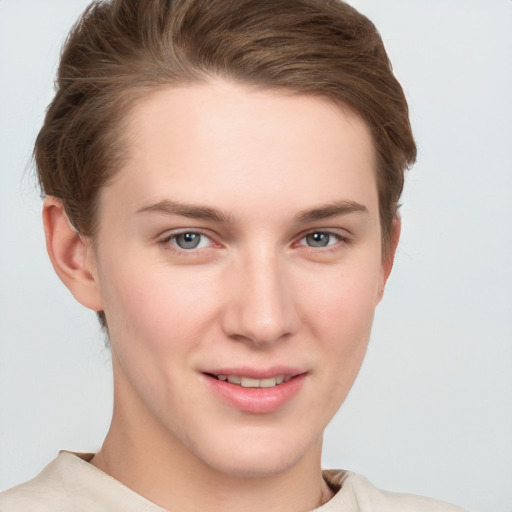 Joyful white young-adult female with short  brown hair and grey eyes