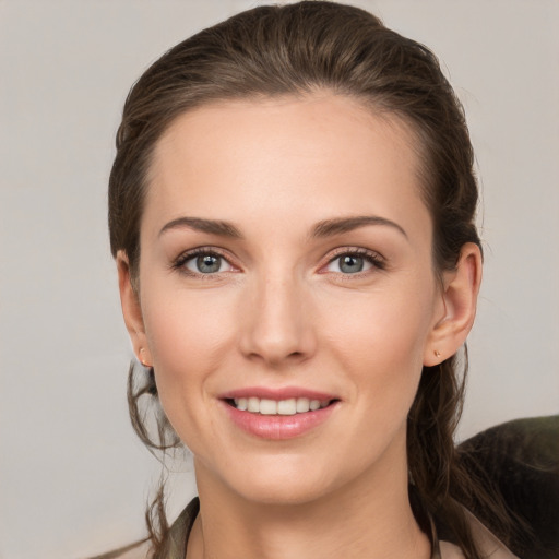 Joyful white young-adult female with medium  brown hair and grey eyes