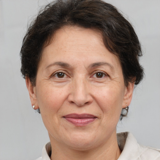 Joyful white middle-aged female with short  brown hair and brown eyes