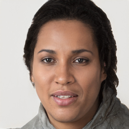 Joyful black young-adult female with long  brown hair and brown eyes