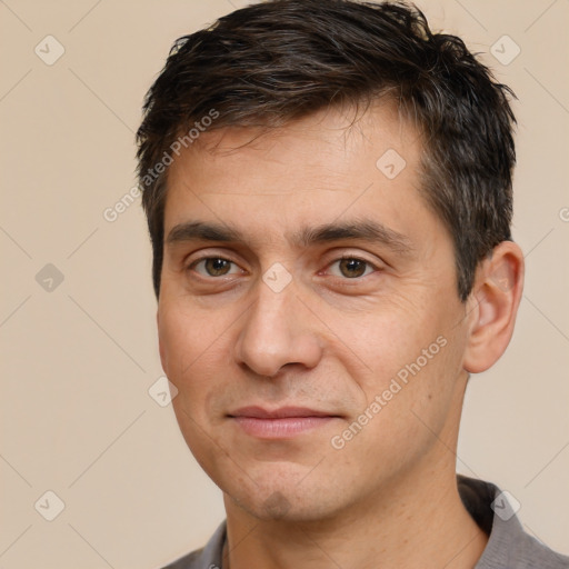 Joyful white adult male with short  brown hair and brown eyes