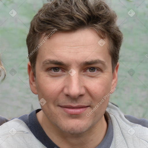 Joyful white adult male with short  brown hair and grey eyes