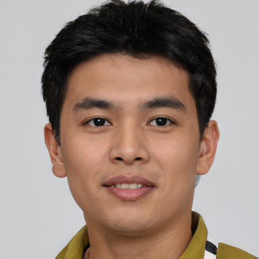 Joyful asian young-adult male with short  brown hair and brown eyes