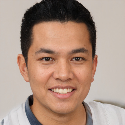 Joyful white young-adult male with short  black hair and brown eyes