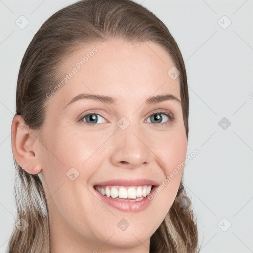 Joyful white young-adult female with long  brown hair and blue eyes