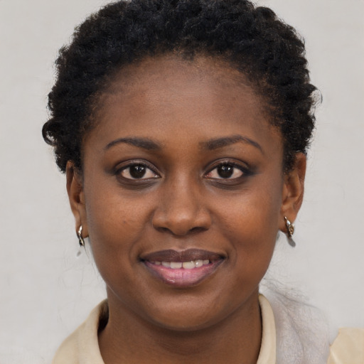 Joyful black young-adult female with short  brown hair and brown eyes