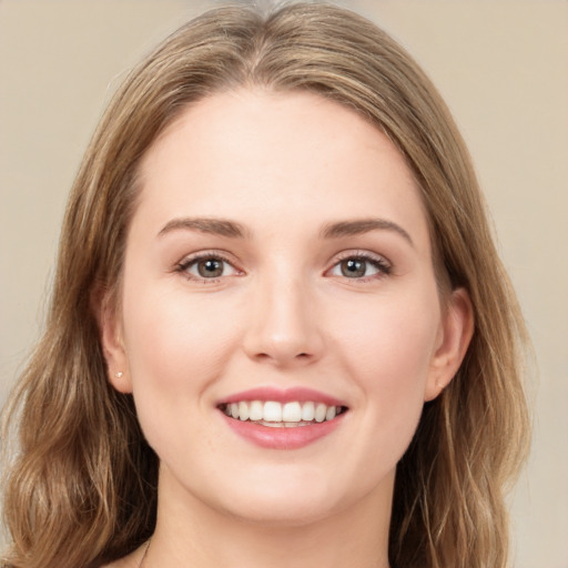 Joyful white young-adult female with medium  brown hair and green eyes