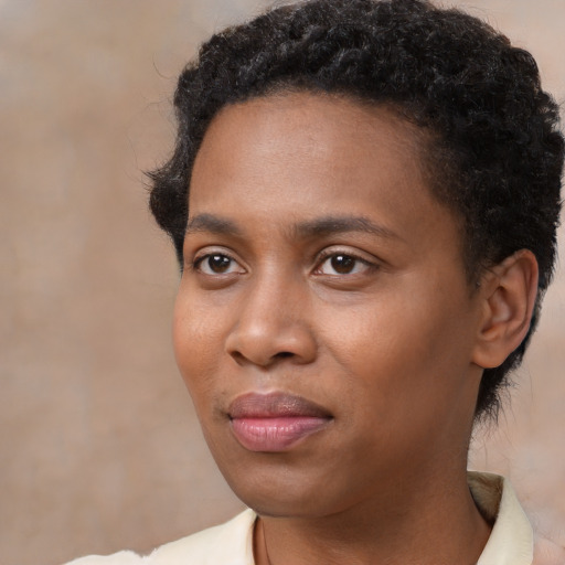 Joyful black young-adult female with short  black hair and brown eyes