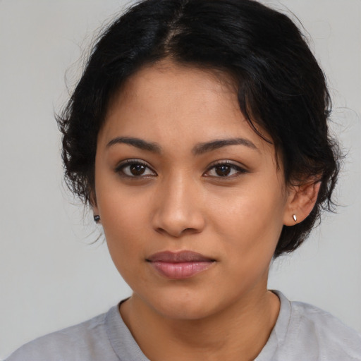 Joyful latino young-adult female with medium  black hair and brown eyes