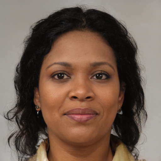 Joyful black young-adult female with medium  brown hair and brown eyes