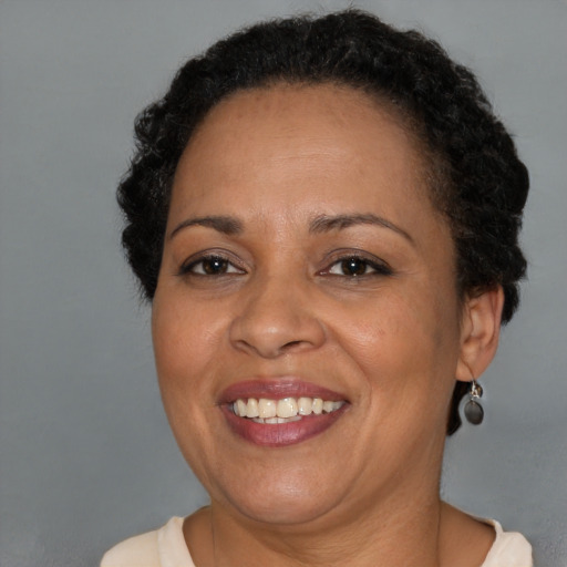 Joyful black adult female with short  brown hair and brown eyes