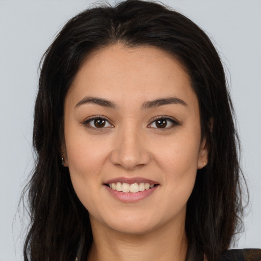 Joyful latino young-adult female with long  brown hair and brown eyes