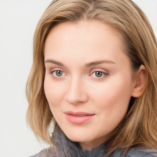 Joyful white young-adult female with long  brown hair and blue eyes