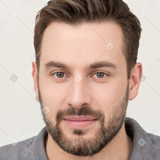 Joyful white young-adult male with short  brown hair and brown eyes