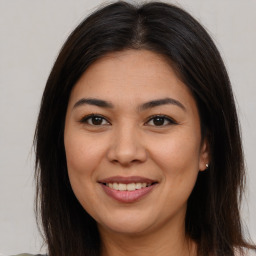 Joyful latino young-adult female with long  brown hair and brown eyes