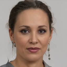 Joyful white adult female with medium  brown hair and brown eyes