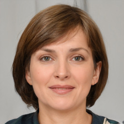 Joyful white adult female with medium  brown hair and grey eyes