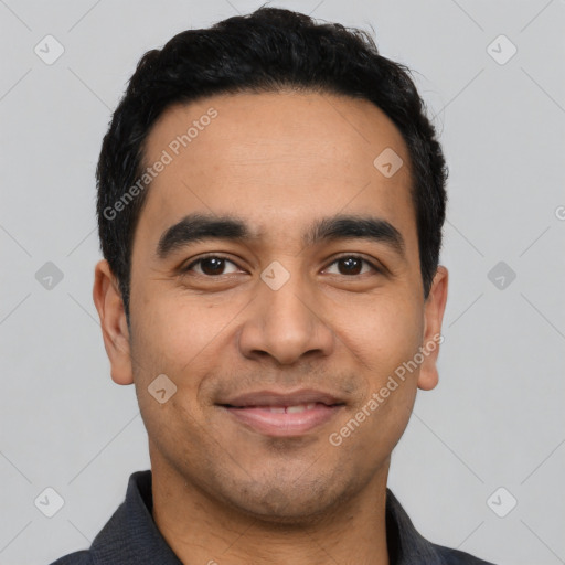 Joyful latino young-adult male with short  black hair and brown eyes