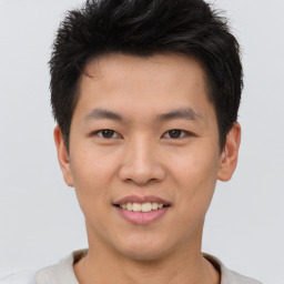 Joyful asian young-adult male with short  brown hair and brown eyes