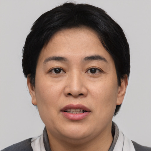 Joyful asian young-adult female with short  brown hair and brown eyes