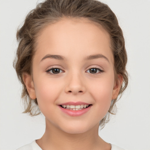 Joyful white child female with medium  brown hair and brown eyes