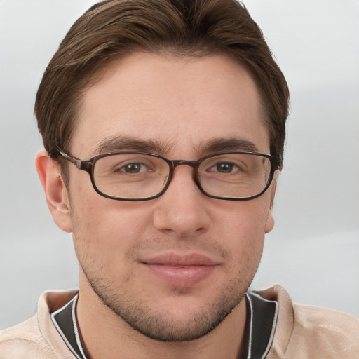 Joyful white young-adult male with short  brown hair and grey eyes