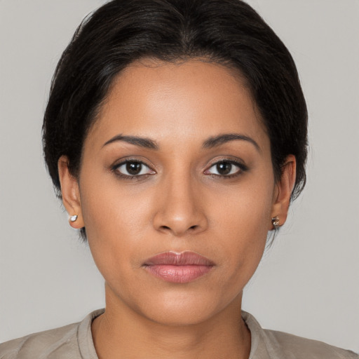 Joyful latino young-adult female with medium  black hair and brown eyes