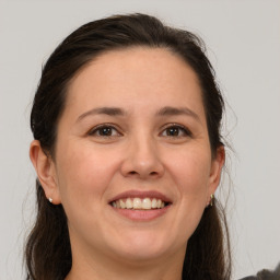 Joyful white adult female with medium  brown hair and brown eyes