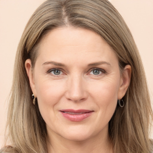 Joyful white adult female with long  brown hair and grey eyes