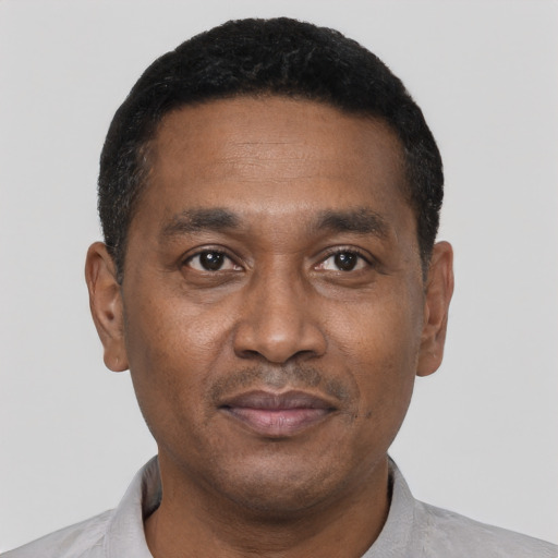 Joyful black adult male with short  black hair and brown eyes