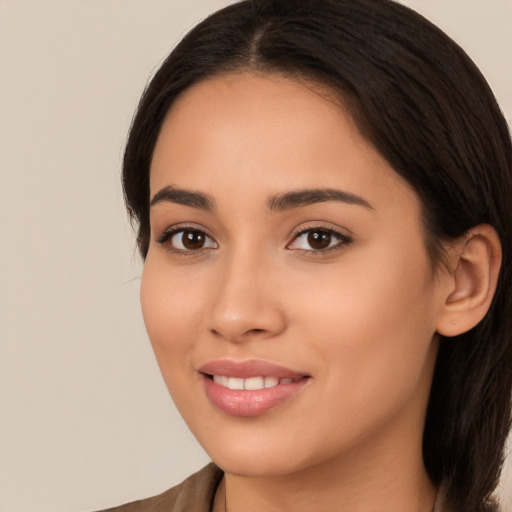 Joyful latino young-adult female with long  brown hair and brown eyes