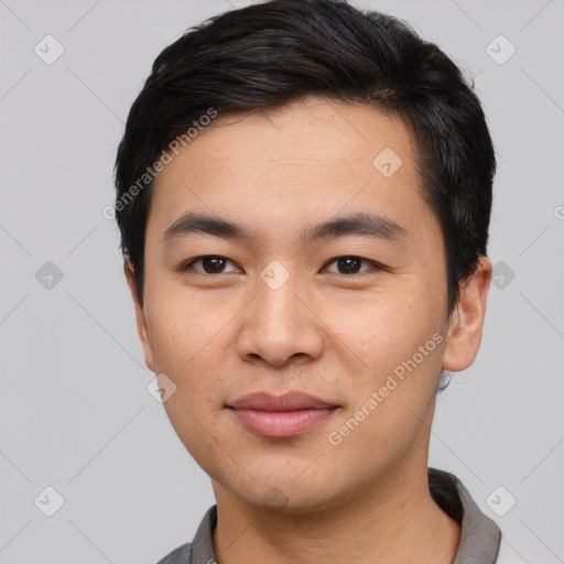 Joyful asian young-adult male with short  black hair and brown eyes