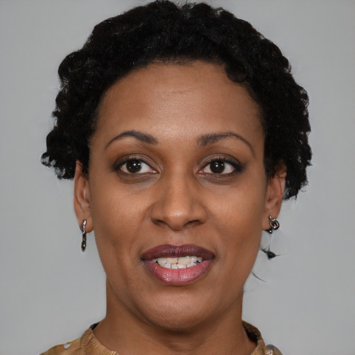 Joyful black adult female with short  brown hair and brown eyes