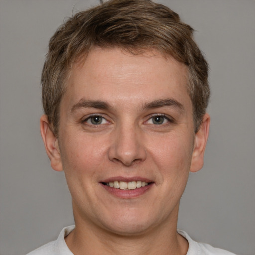 Joyful white adult male with short  brown hair and brown eyes