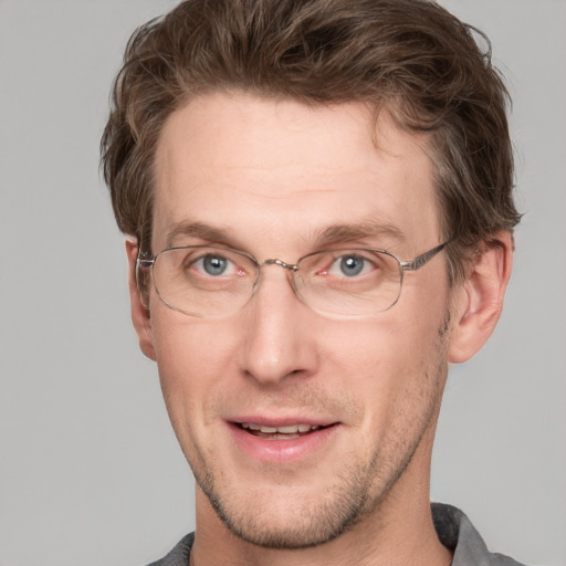 Joyful white adult male with short  brown hair and grey eyes