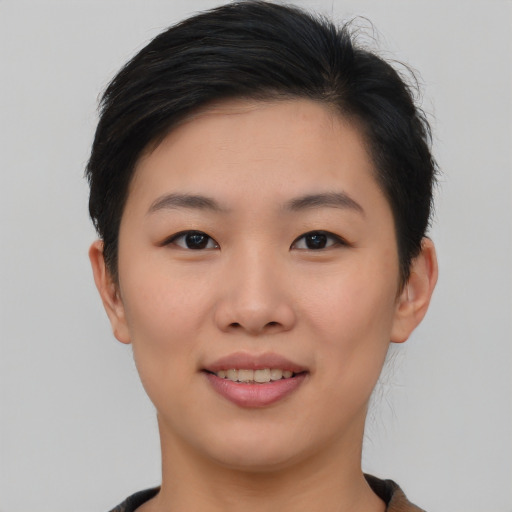 Joyful asian young-adult female with short  brown hair and brown eyes