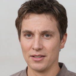 Joyful white adult male with short  brown hair and brown eyes