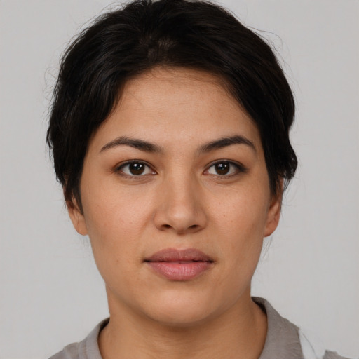 Joyful asian young-adult female with short  brown hair and brown eyes