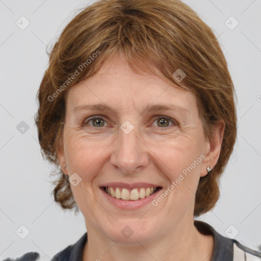 Joyful white adult female with medium  brown hair and grey eyes