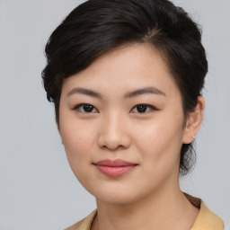 Joyful asian young-adult female with medium  black hair and brown eyes