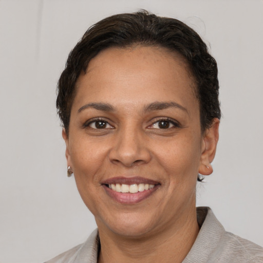 Joyful white adult female with short  brown hair and brown eyes