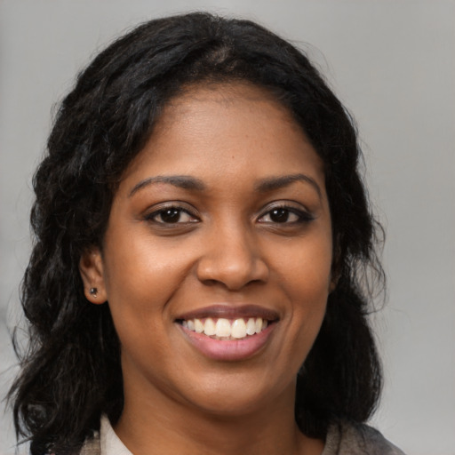 Joyful black young-adult female with medium  black hair and brown eyes