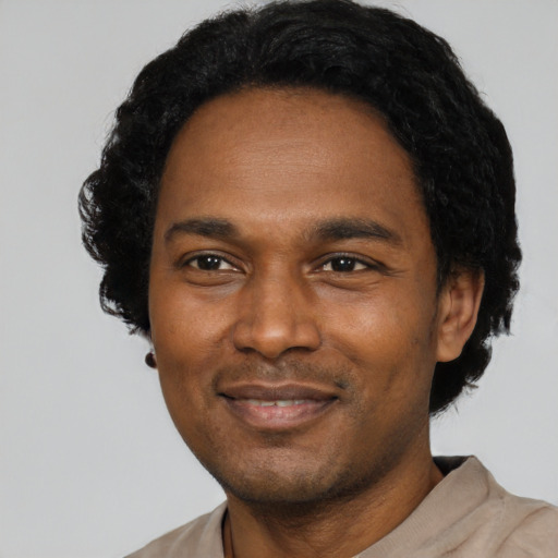 Joyful latino adult male with short  black hair and brown eyes