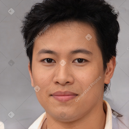 Joyful asian young-adult male with short  brown hair and brown eyes